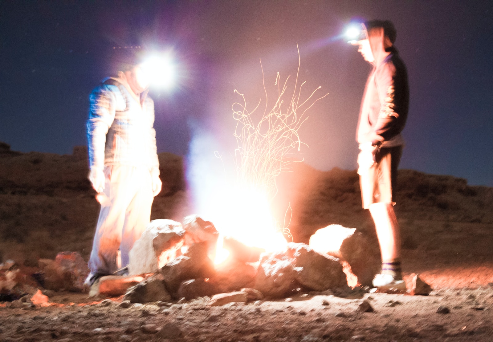 two men standing in front of rocks